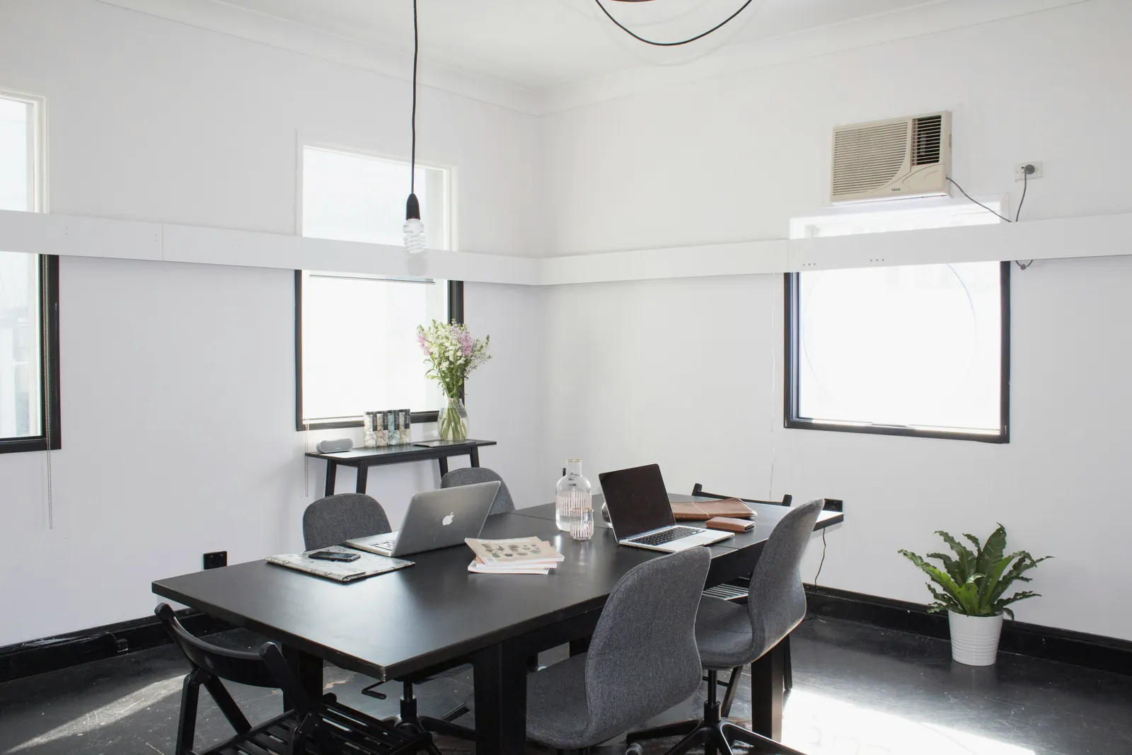 An empty meeting room with notebooks on the table before a session.